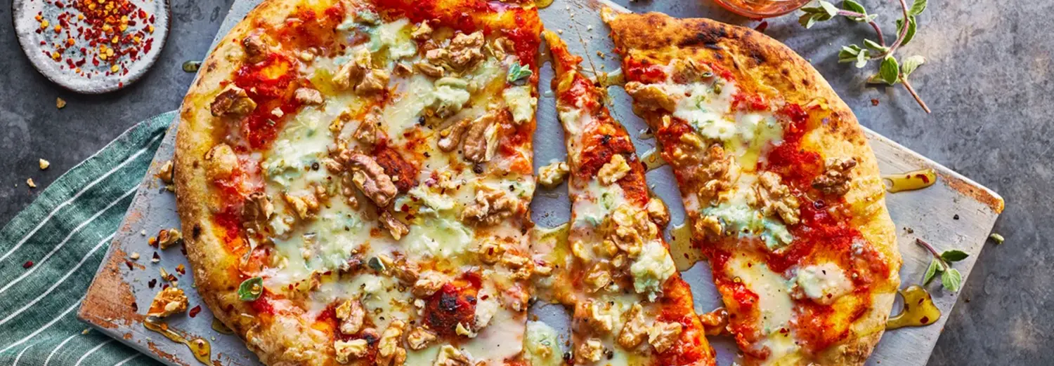 close-up food photography of cheesy pizza with crispy toppings