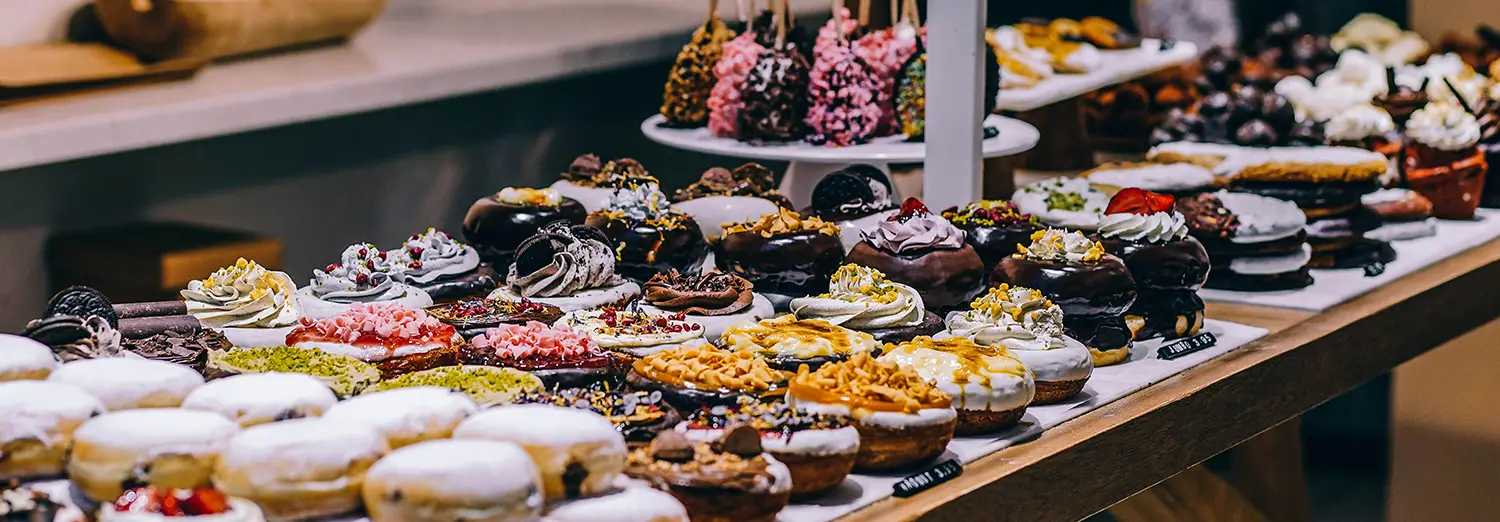 food photography of assorted donuts displayed on bakery counter