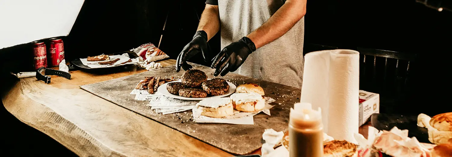 food photography of chef preparing gourmet burgers on cutting board