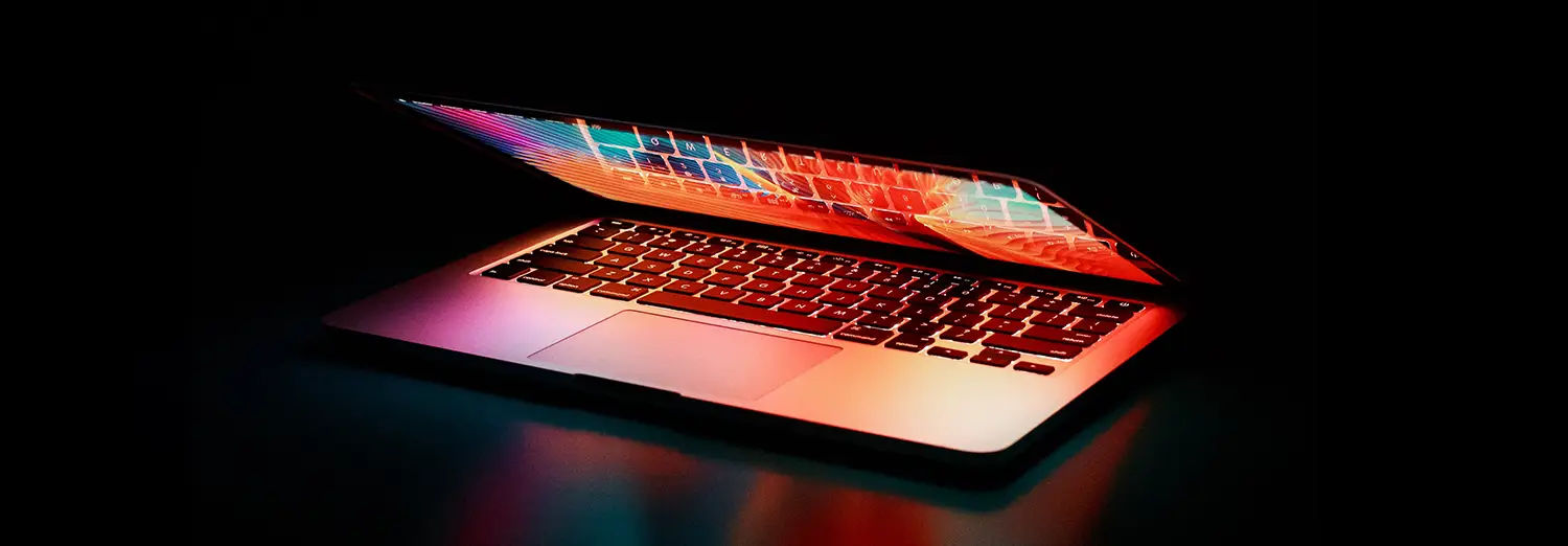 graphic design close-up of laptop with vibrant screen lighting