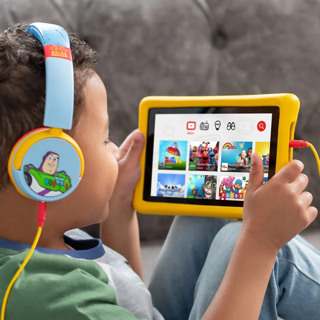 child wearing headphones while using digital design kids tablet